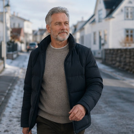 A man in his fifties walking outdoors on a bright Nordic morning